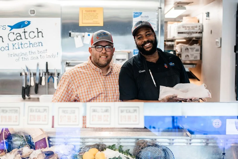 Caplinger's team members at the market counter